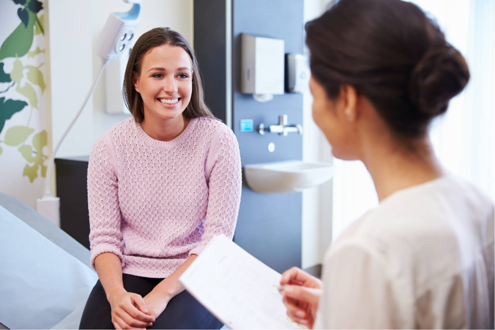 Female Patient And Doctor Have Consultation In Hospital