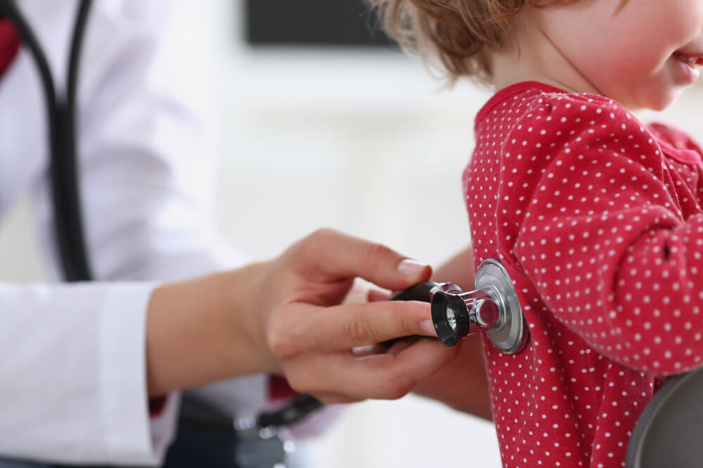 Little child with stethoscope at doctor reception