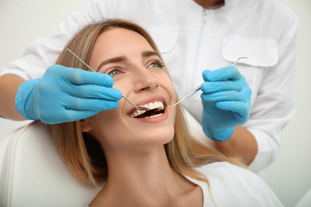 A woman receiving her dental oral exam