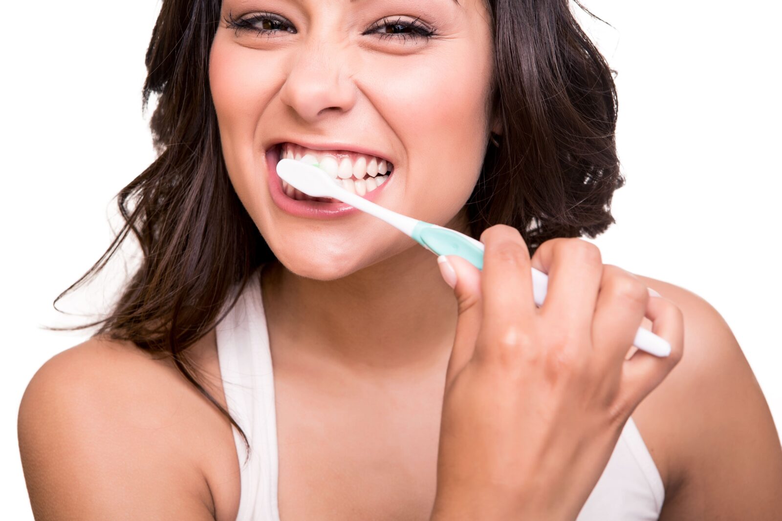 woman smiling and brushing her teeth