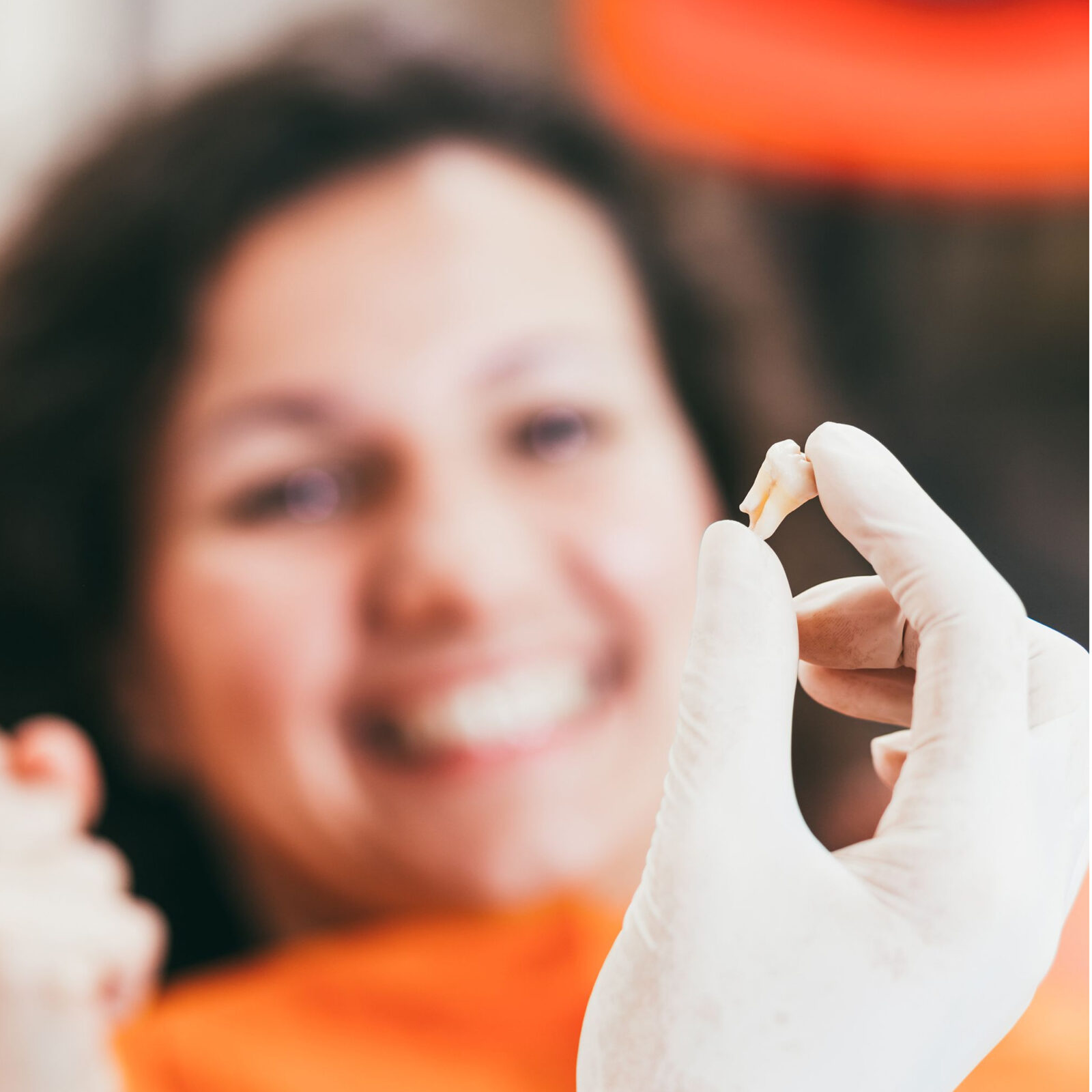 A woman smiling after Oral Surgery, Teeth Extraction