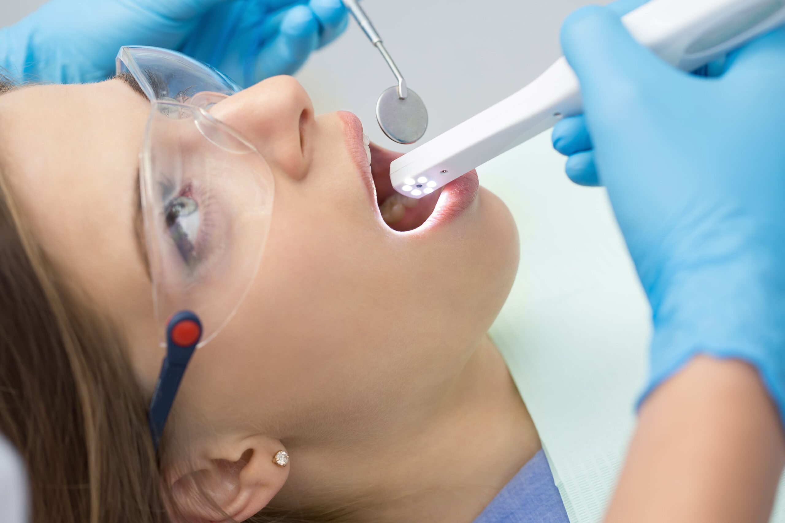 woman having an intraoral camera used in her mouth