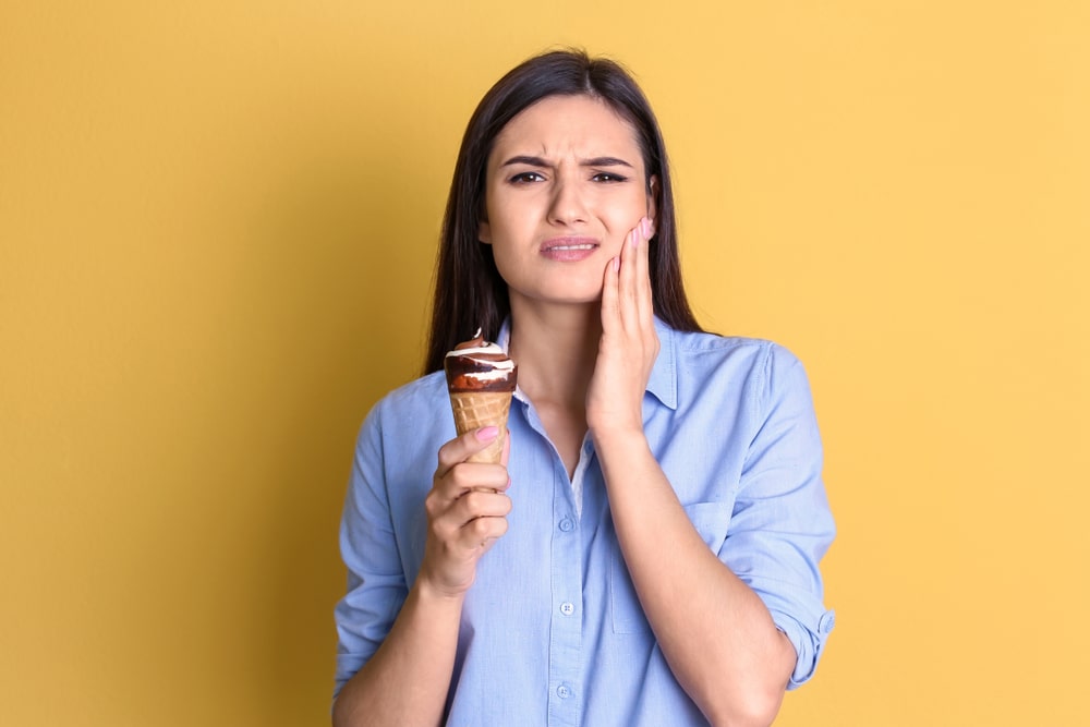 woman eating ice cream with sensitive teeth