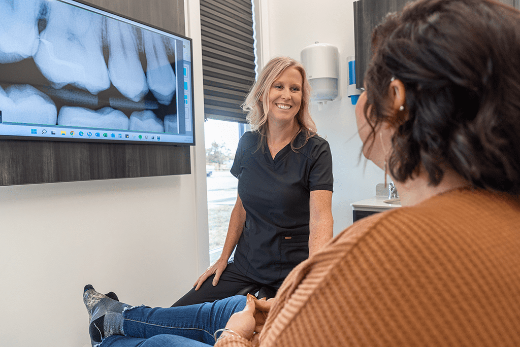 Our dentist discussing all on 4 dental implants in Beaverlodge with a patient.