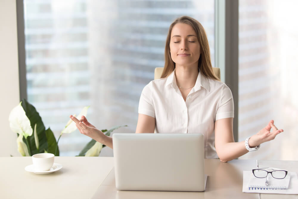 businesswoman practices breathing exercise