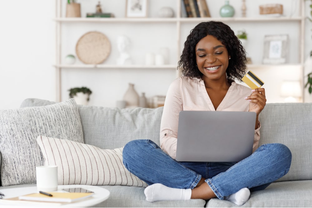 Young Girl Using Laptop and Credit Card