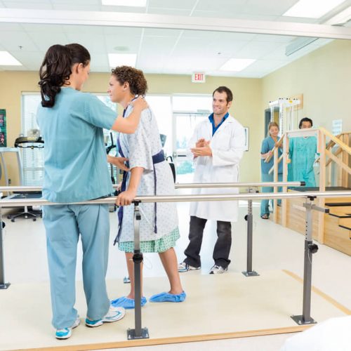 female patient being assisted by physical therapist