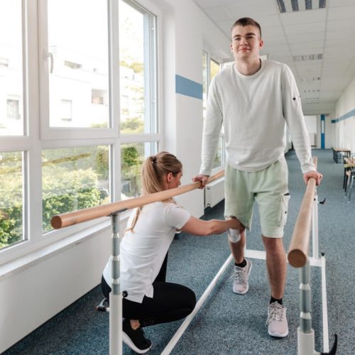 Young man walking in rehabilitation course