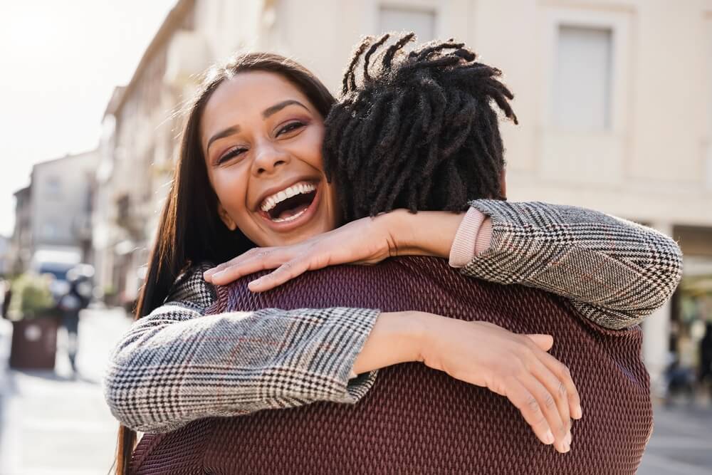 Girlfriend hugging her friend