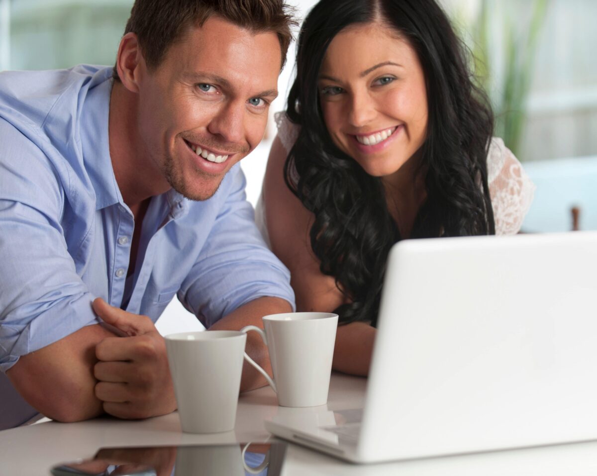 Smiling Couple looking at laptop together