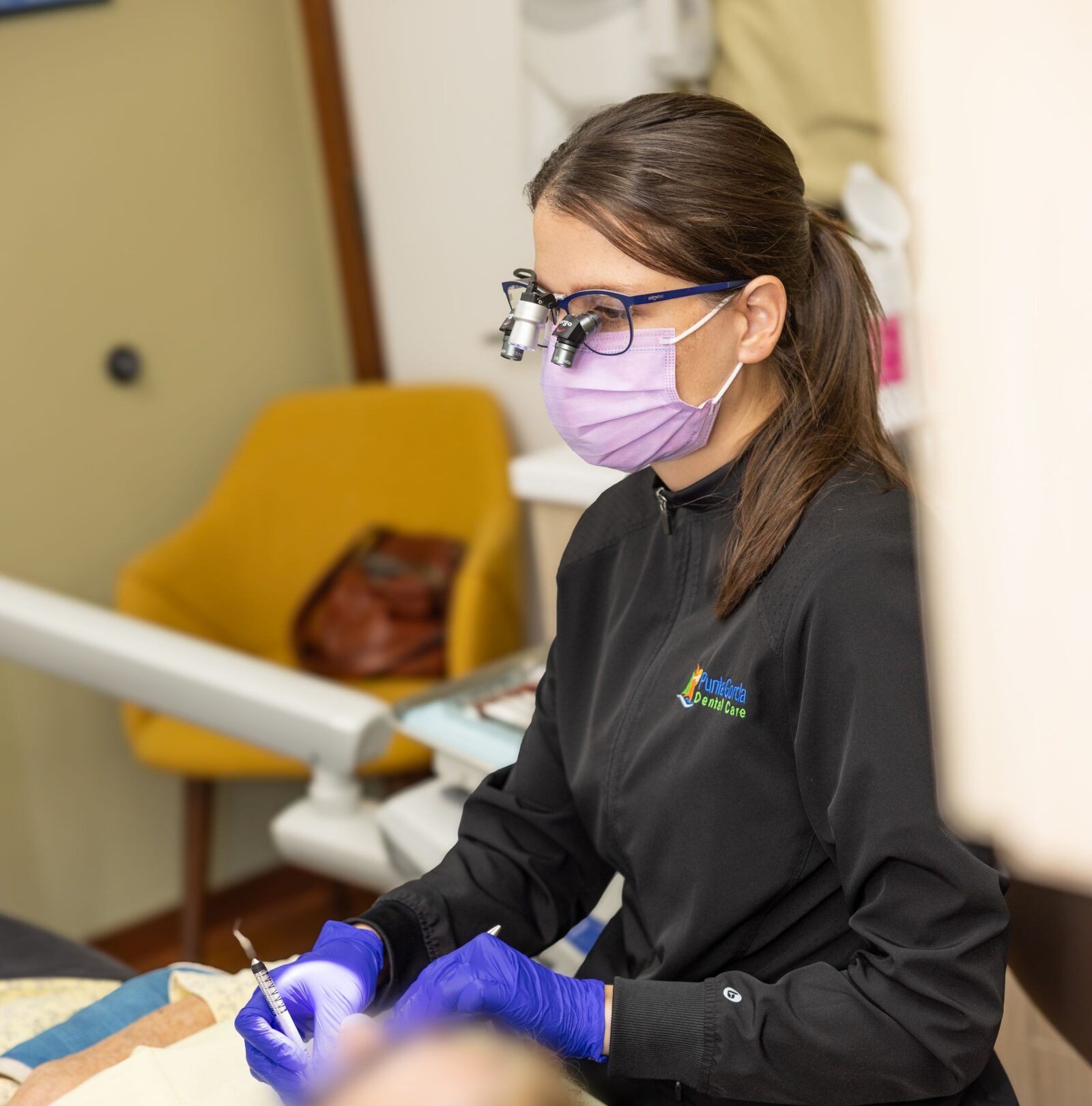 Female Dental Hygienist working on patient