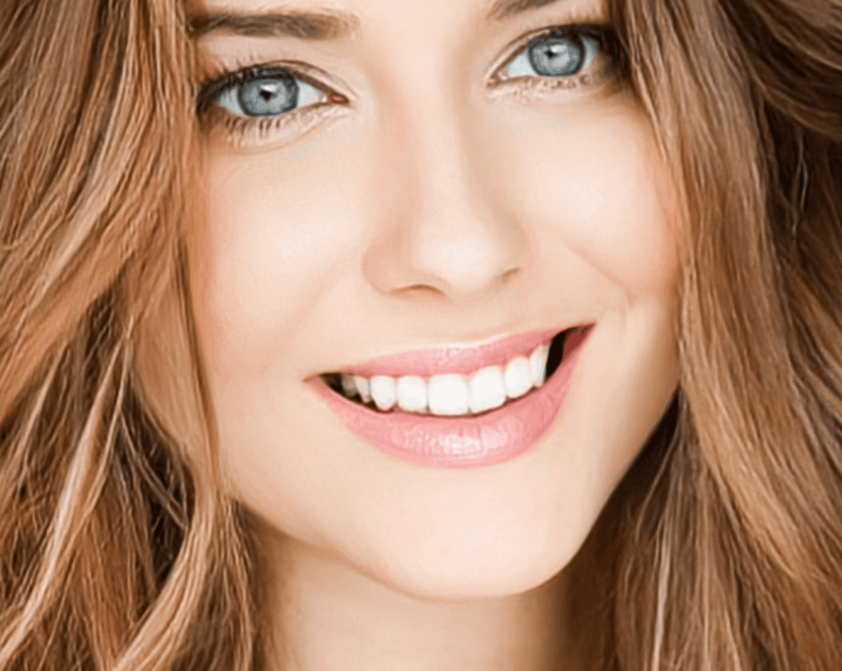 Smiling woman showing off her perfect looking teeth