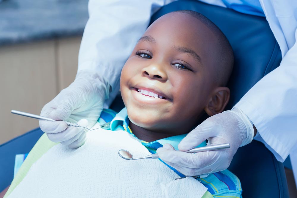 boy having his teeth examined by a dentist