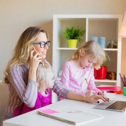 Mom with two daughters working from home