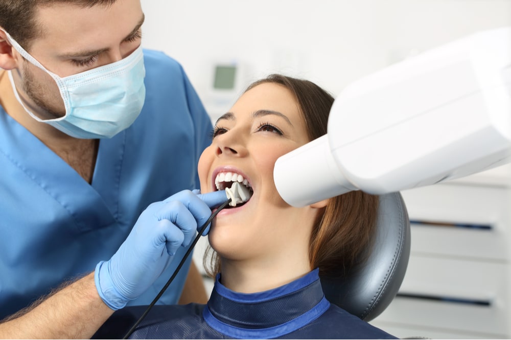 Dentist taking a teeth radiography to a patient