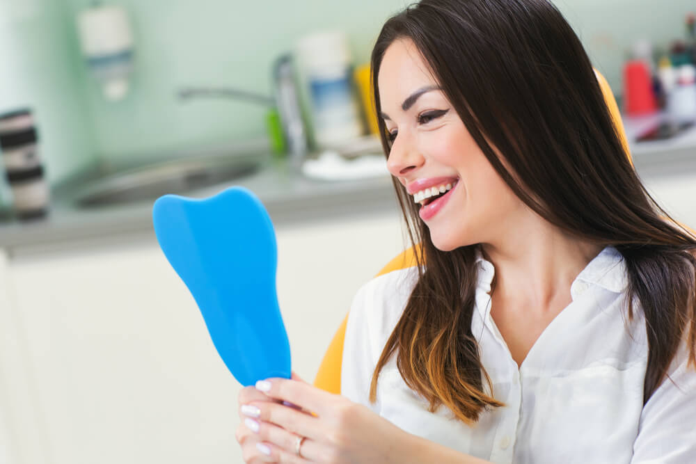 young woman checking teeth