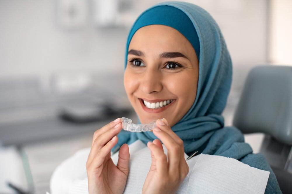 women holding Transparent Aligner