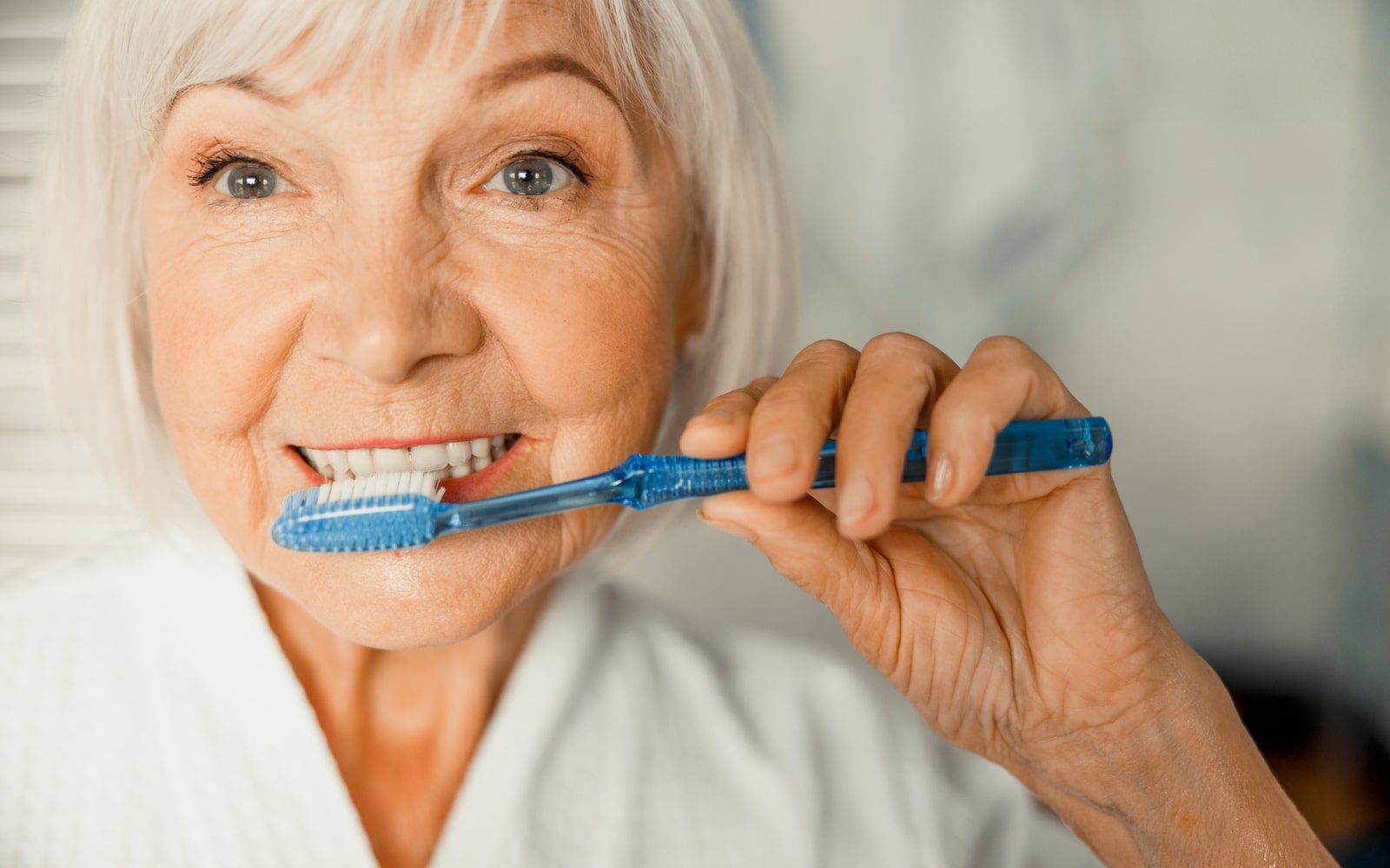 Elderly Women Taking Care of Her Teeth