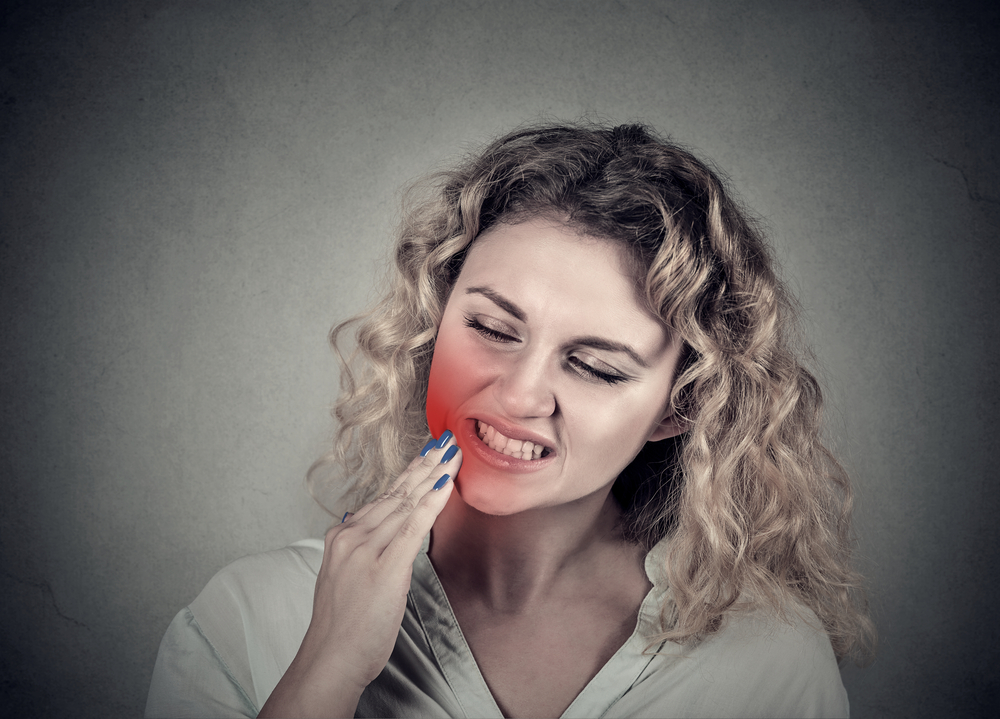 Closeup portrait young woman with sensitive tooth ache