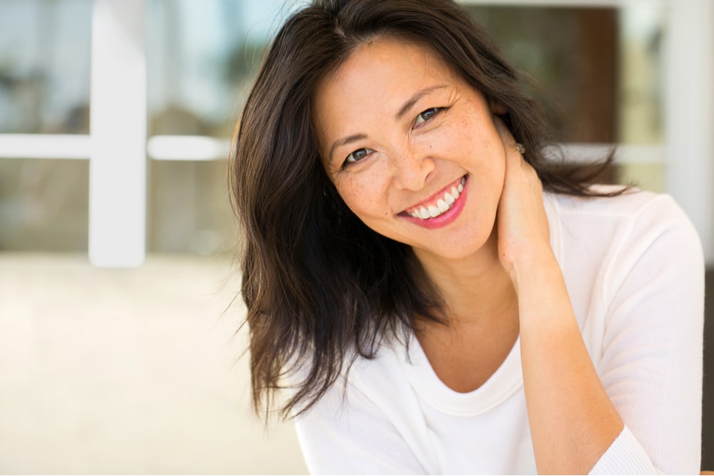 Middle age Asian woman with perfect smile