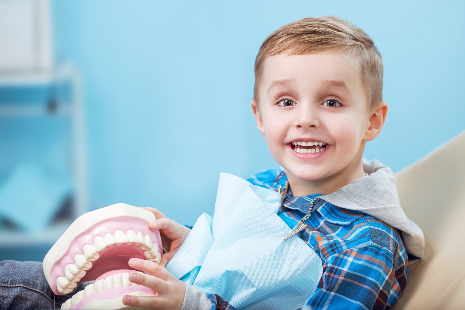 happy boy sitting in dental chair