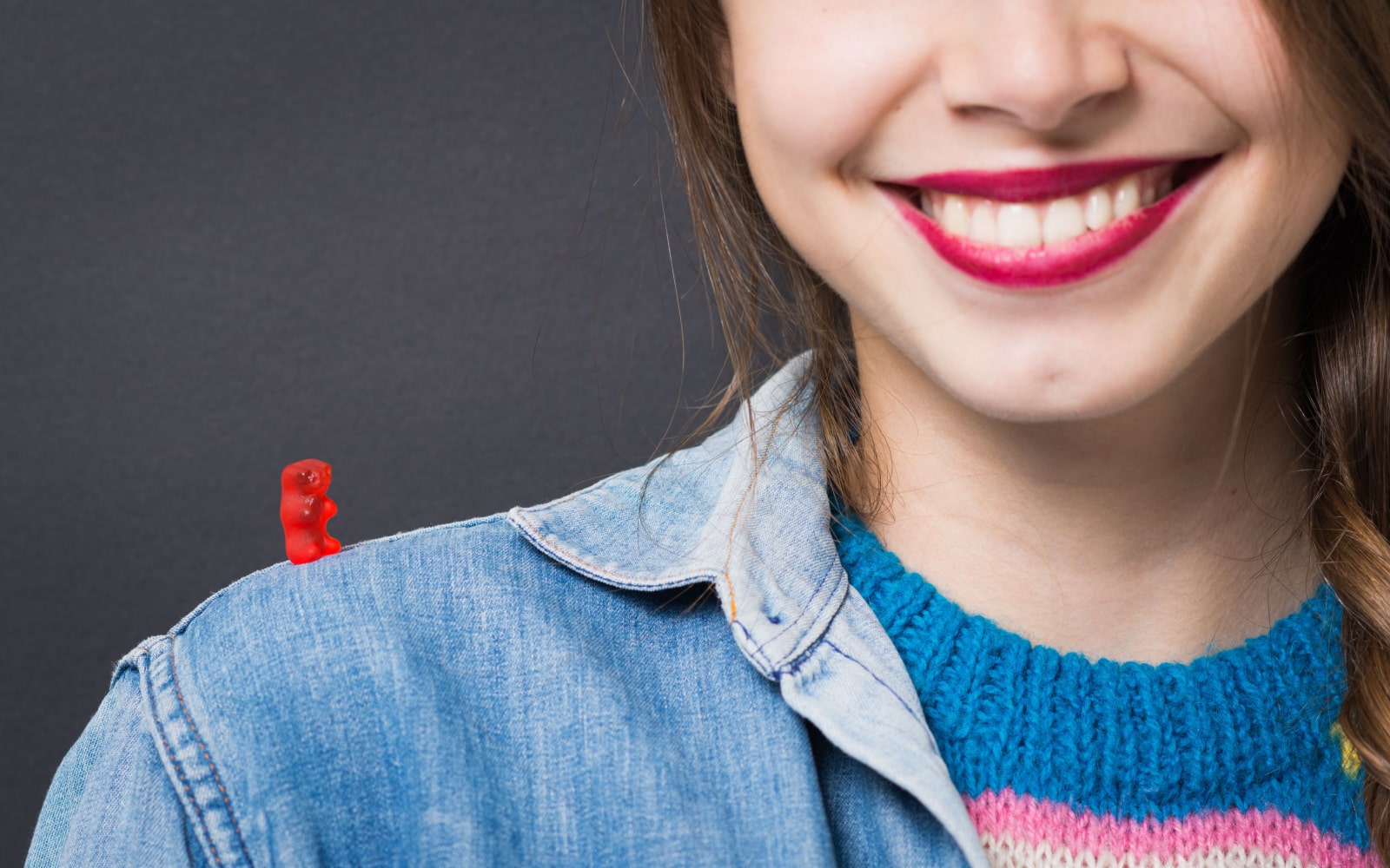 Woman Smiling with Gummy Bear On Shoulder