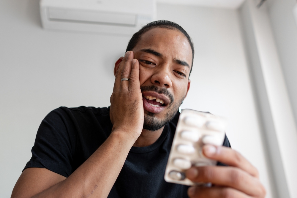 Colombian boy just broke his tooth and is looking at the medication he has to take.