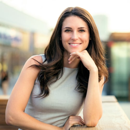 brunette woman happy and smiling on rooftop