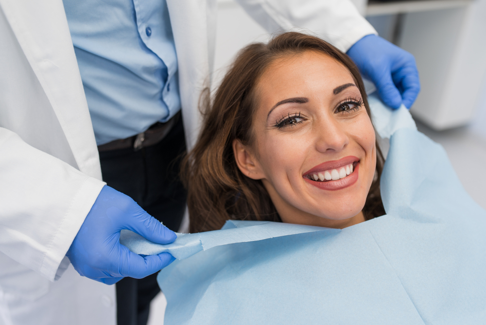 A woman smiling after receiving Dental Exams