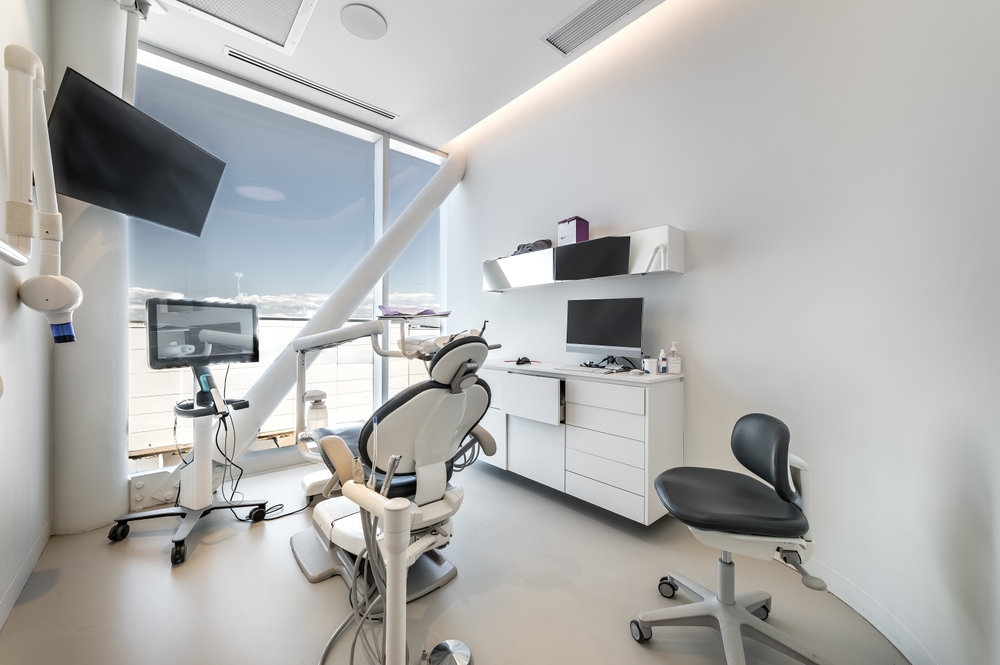 Modern dental office interior with reception, dental chairs and treatment rooms