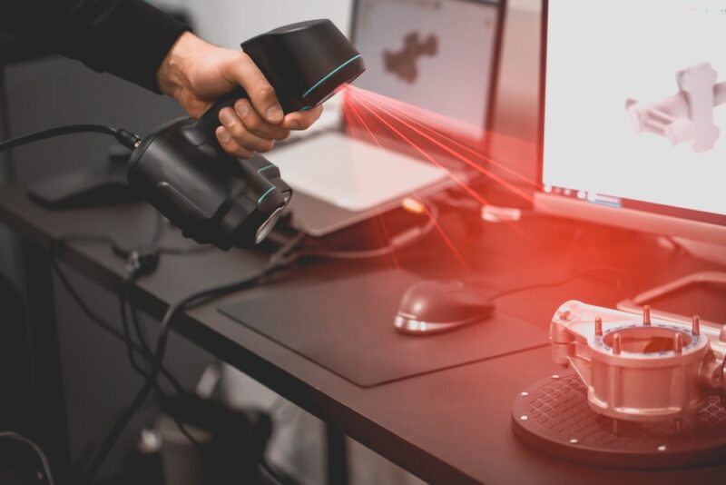 Man Using Portable Scanner to Import 3D CAD Model of Complex Mechanical Part into Computer - Image