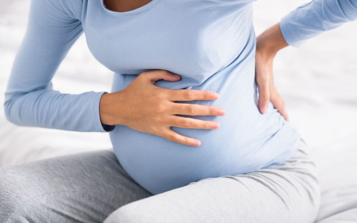 Woman Experiecing Cramps During Pregnancy