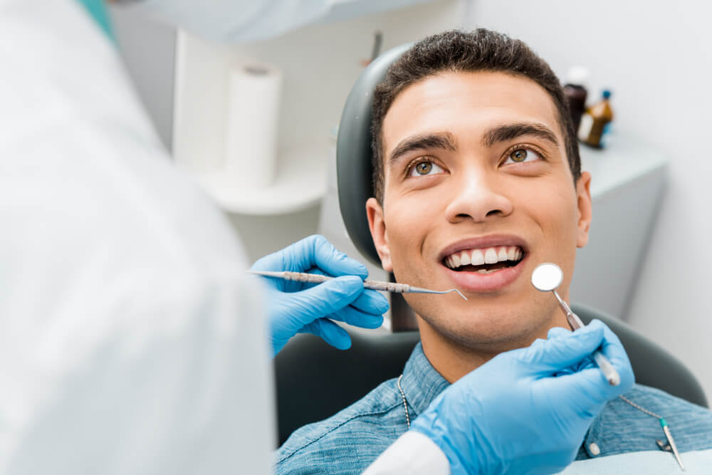 cheerful man during examination in dental clinic