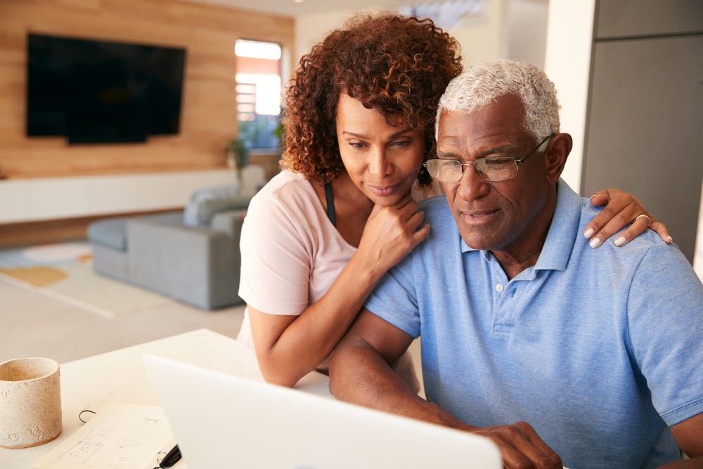 Senior Couple Using Laptop To Check Finances At Home