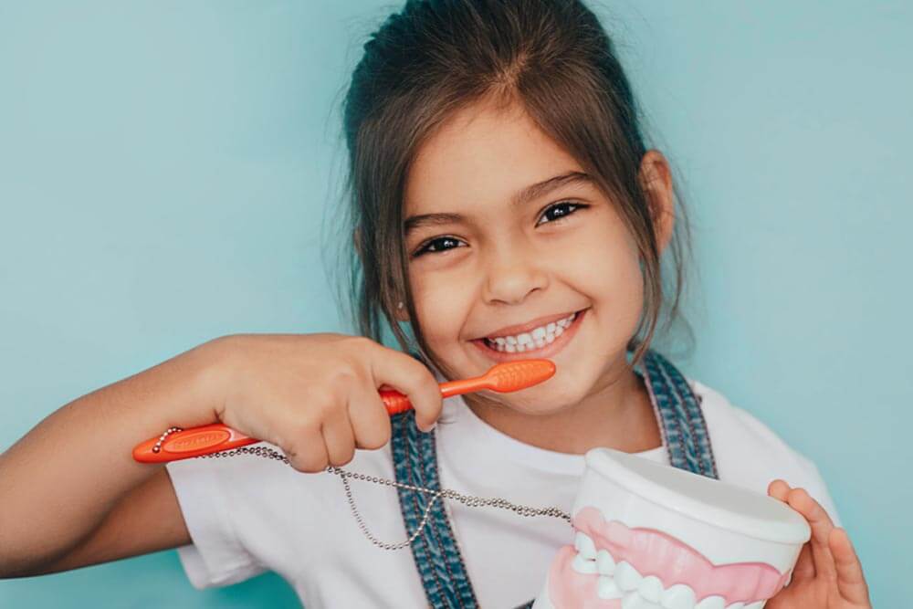 smiling girl brushing teeth