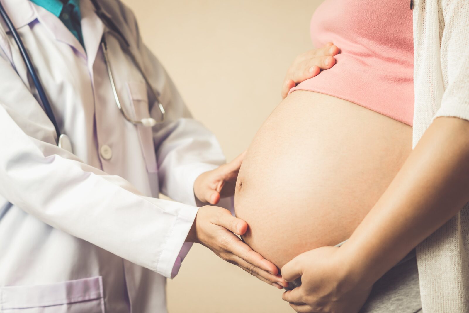 pregnant woman being seen by obstetrician 