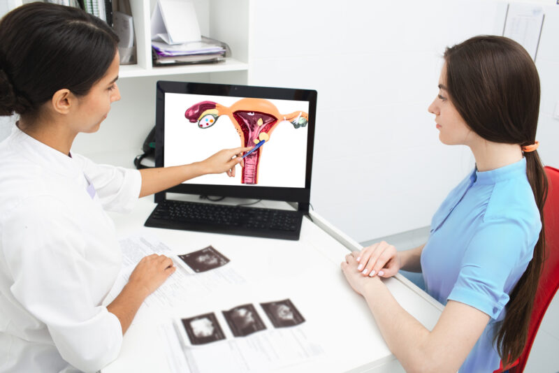 Gynecology, consultation. Gynecologist explains to a woman about a disease of the uterus