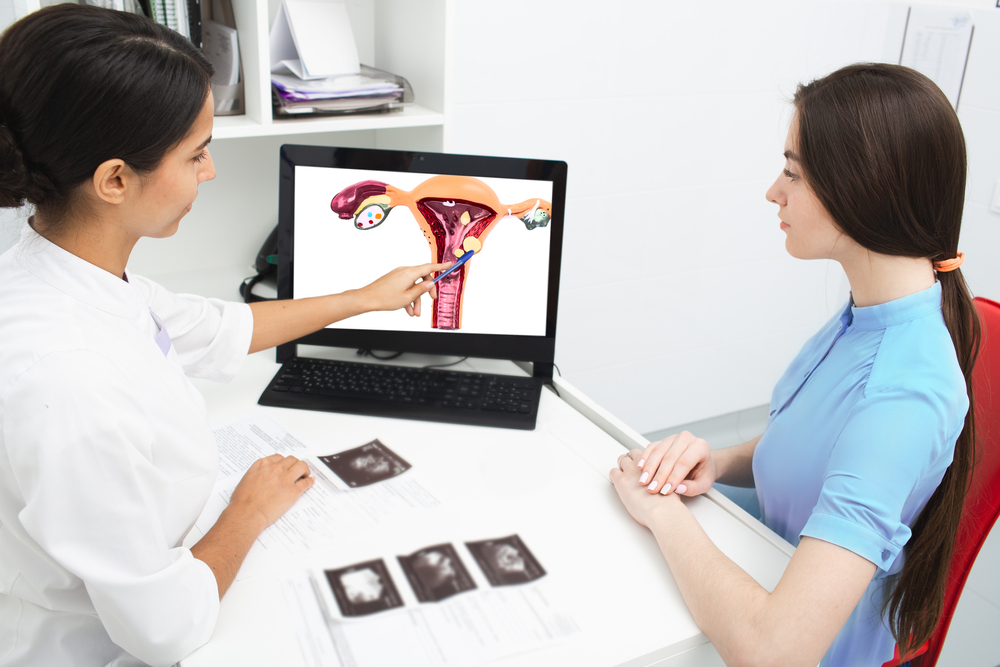 Gynecology, consultation. Gynecologist explains to a woman about a disease of the uterus
