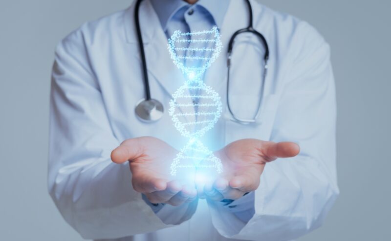 Cropped of medical doctor geneticist hands holding DNA chain hologram