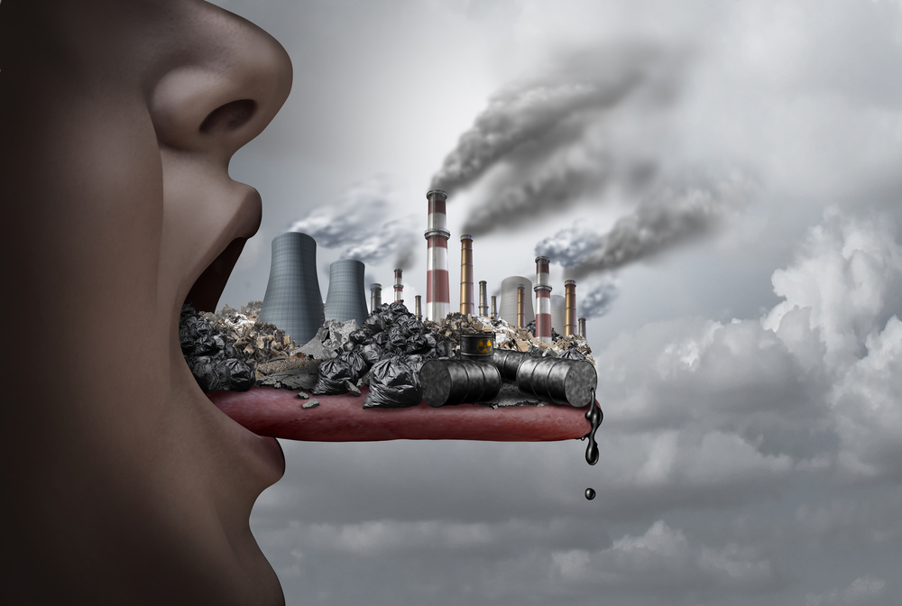 Toxic pollutants inside the human body and eating pollutants as an open mouth ingesting industrial toxins