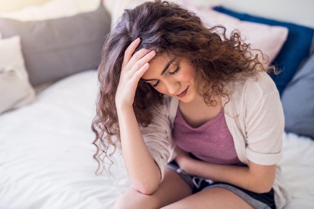 Woman suffering from menstrual pain, having cramps.