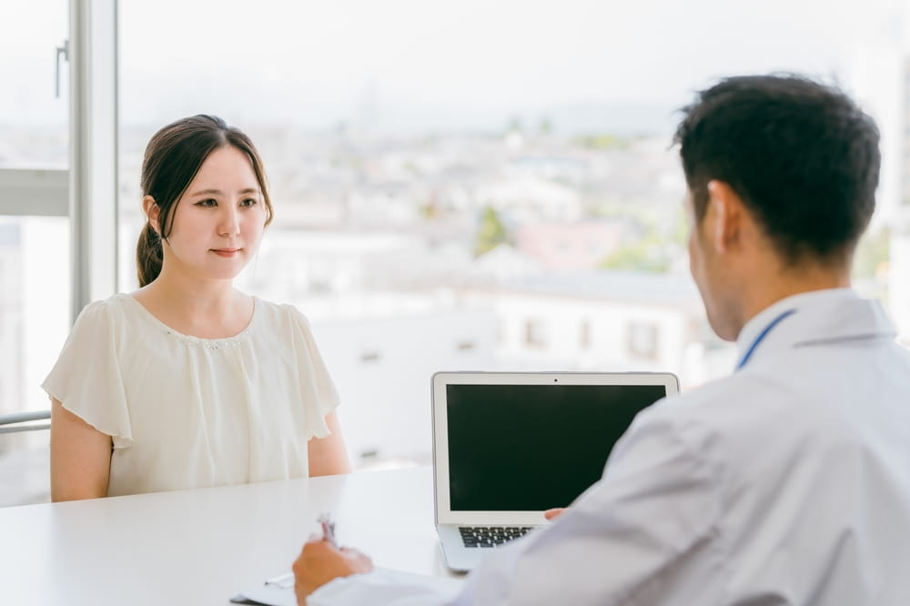 A female patient being diagnosed with an illness (disease, prognosis, cancer, insurance)