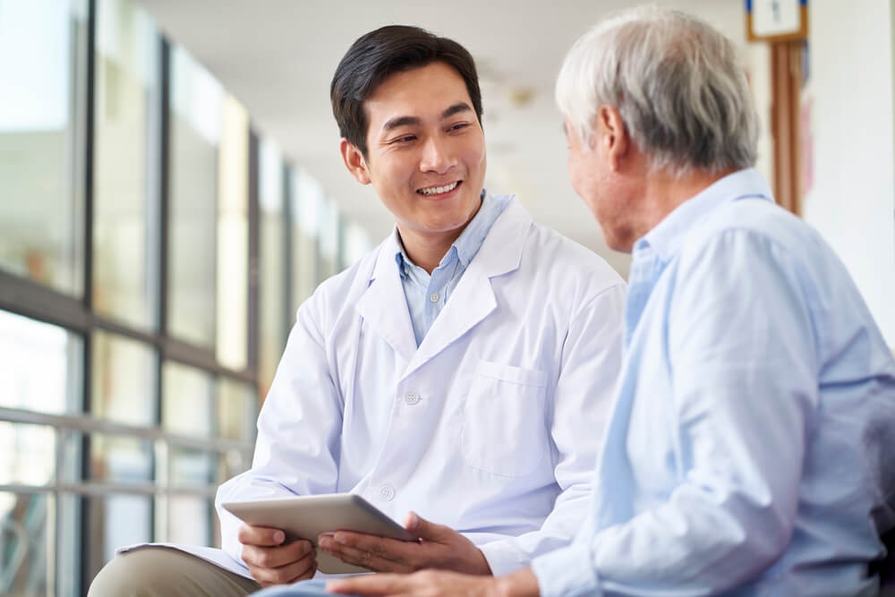 doctor talking and explaining test result to elderly patient