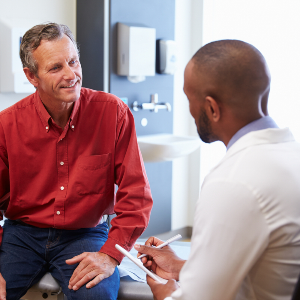 Male Patient And Doctor Have Consultation In Hospital