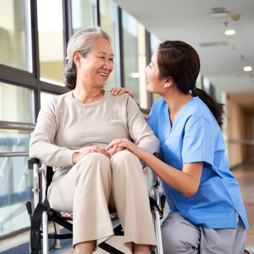 friendly nurse talking to senior woman