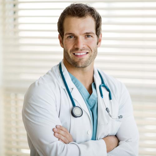 male doctor with arms crossed standing at clinic