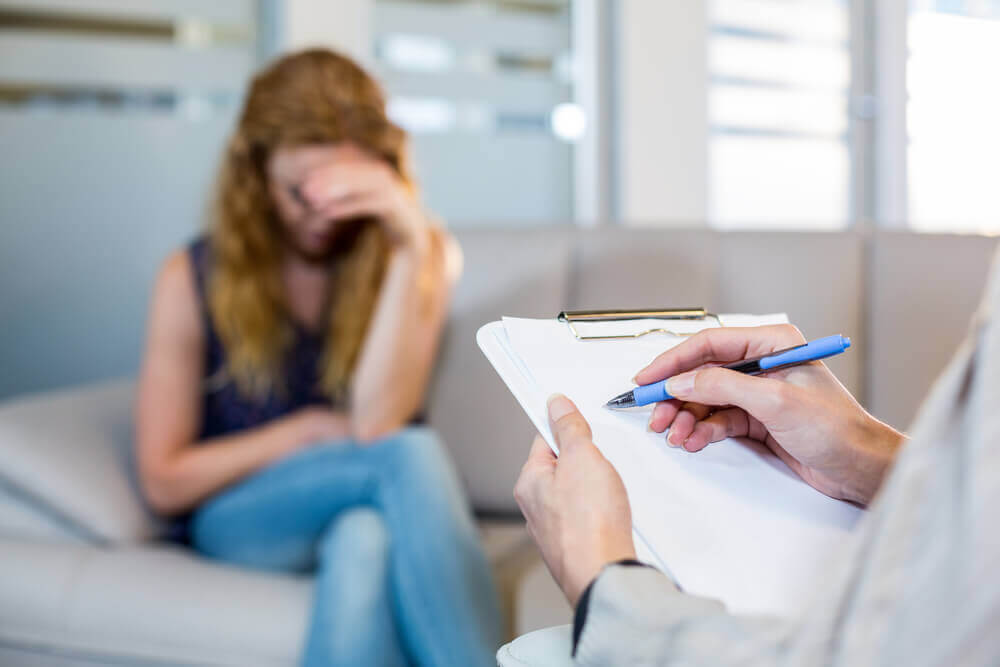 Young woman and counselor discussing EMDR