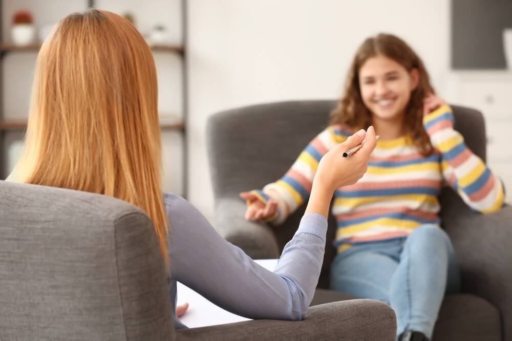 Teen girl and counselor participating in a neurodiverse intensive outpatient program for teens