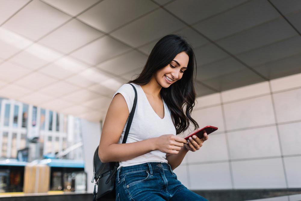 cheerful woman smile using mobile phone