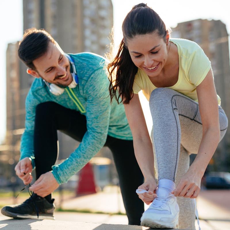 Runners tying running shoes and getting ready to run